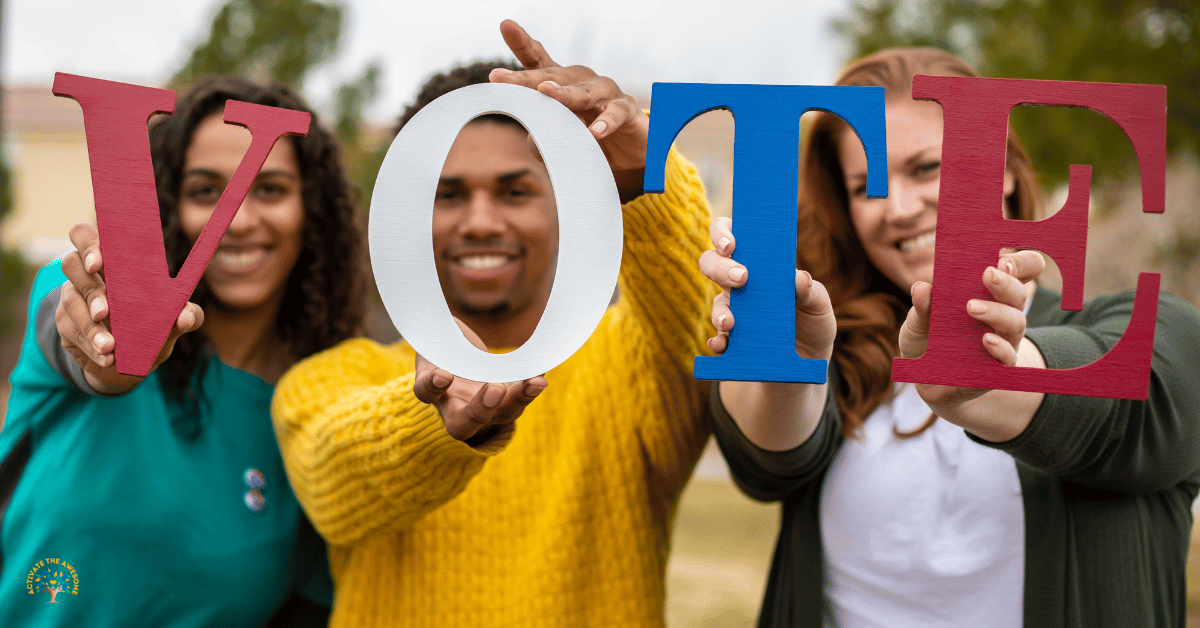 Photo of three people holding the letters V, O, T, and E