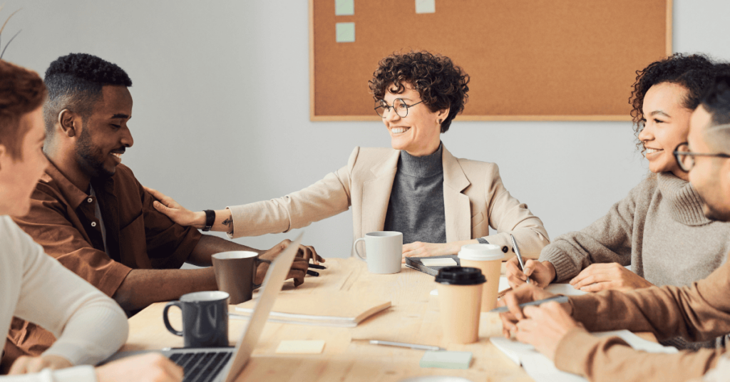 Photo of engaged, smiling coworkers around a table